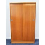 LIGHT OAK WARDROBE with two sliding doors opening to reveal a shelf and slide out hanging rails,