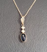 CABOCHON SAPPHIRE AND SEED PEARL SET PENDANT in fourteen carat gold and on fourteen carat gold
