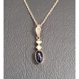 CABOCHON SAPPHIRE AND SEED PEARL SET PENDANT in fourteen carat gold and on fourteen carat gold