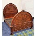 MAHOGANY DOUBLE BED with an arched panelled head and footboard together with a sprung base, 200cm