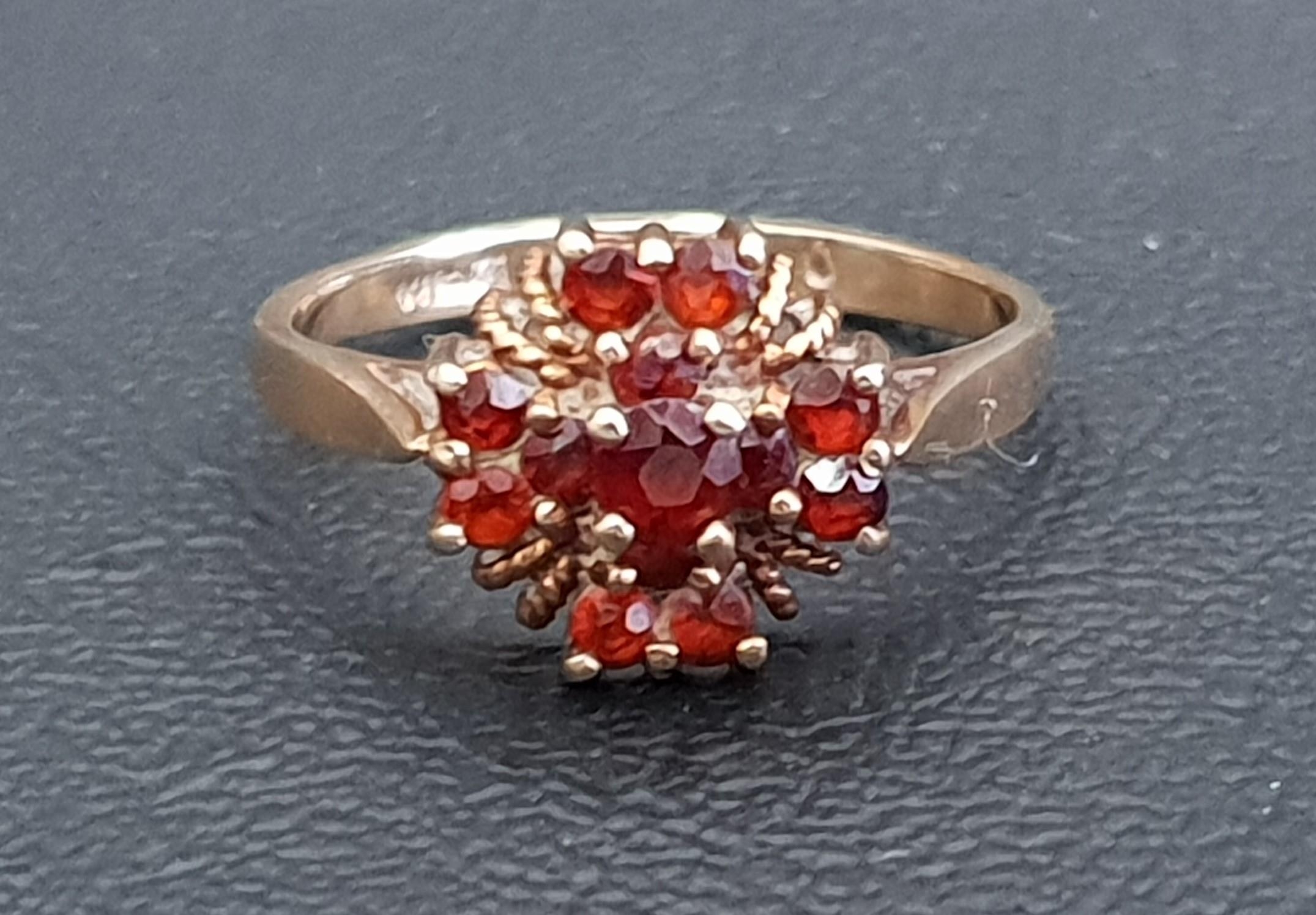 GARNET CLUSTER RING on nine carat gold shank, ring size L and approximately 1.9 grams