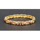 TWENTY-ONE CARAT GOLD BANGLE the relief moulded and textured bangle with enamel and paste