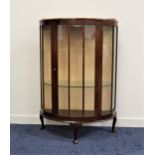1950s MAHOGANY BOW FRONT DISPLAY CABINET with a raised back above a central glazed door flanked by