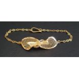 HIGH CARAT GOLD BRACELET with central pierced bow, with Arabic mark, testing as high carat,