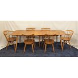 ERCOL LIGHT OAK DINING TABLE AND CHAIRS the table with a pull apart top and two extra leaves,