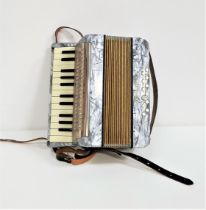 HOHNER MIGNON II ACCORDIAN with leather shoulder straps and a grey body