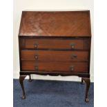 MAHOGANY BUREAU with a fall flap and fitted interior above three drawers, standing on cabriole