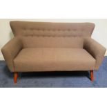 RETRO STYLE WING BACK SOFA with a shaped button back above shaped arms, standing on tapering
