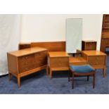 UNIFLEX TEAK BEDROOM SUITE comprising a double bed headboard with built in bedside cupboards with