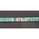 EMERALD AND DIAMOND BRACELET the central emeralds separated by small illusion set diamonds, in