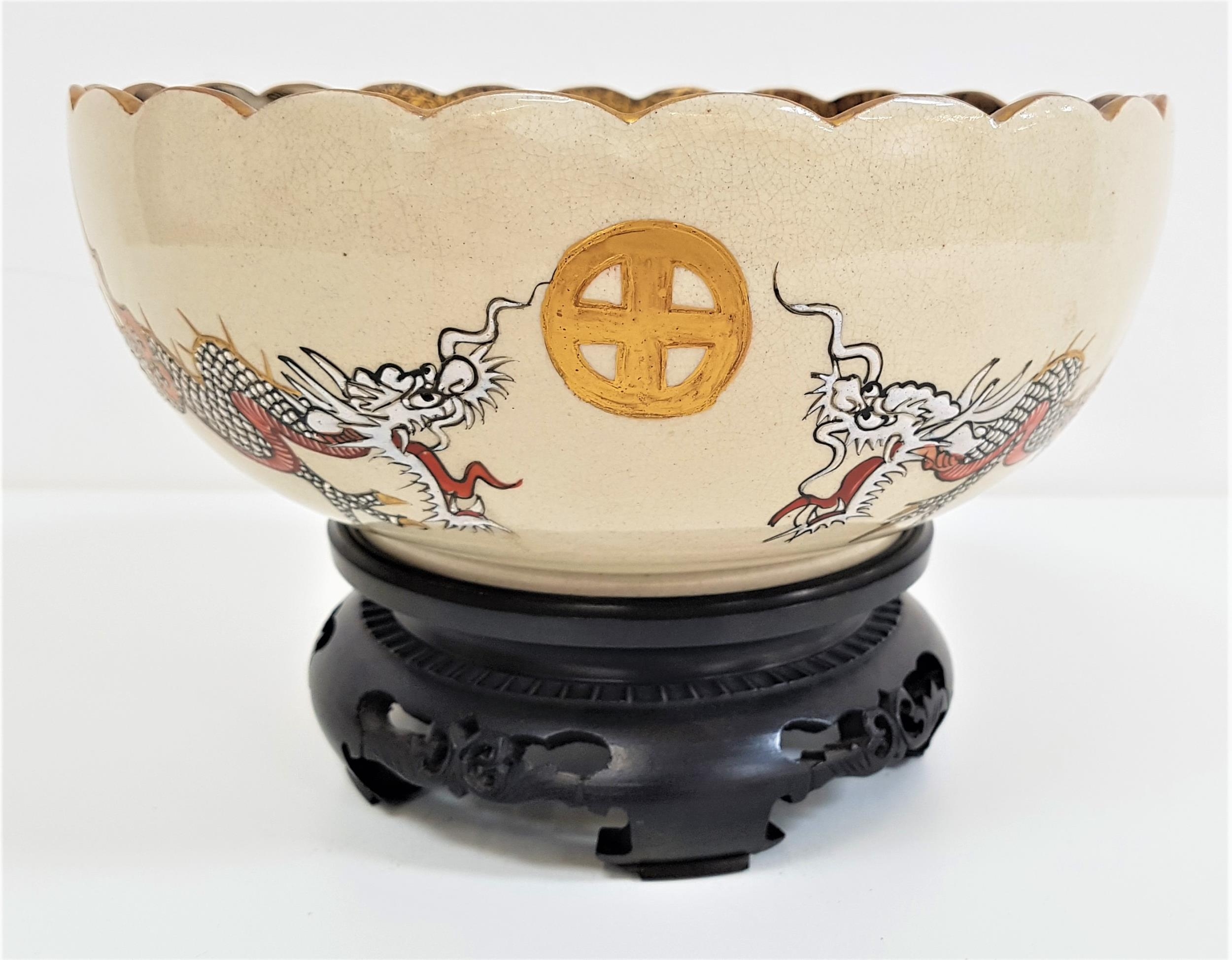 JAPANESE SATSUMA BOWL with a scalloped gilt edge rim, the bowl decorated with two dragons and many