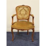 20th CENTURY WALNUT FAUTEILLE ELBOW CHAIR with a shaped padded back, arms and seat, standing on