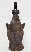 BENIN BRONZE ANIMAL HEAD with textured decoration, surmounted with a similar cat like animal, 50cm