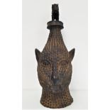 BENIN BRONZE ANIMAL HEAD with textured decoration, surmounted with a similar cat like animal, 50cm