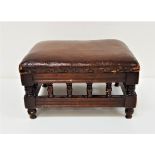EDWARDIAN MAHOGANY FOOTSTOOL with a rectangular padded top above galleried turned columns,