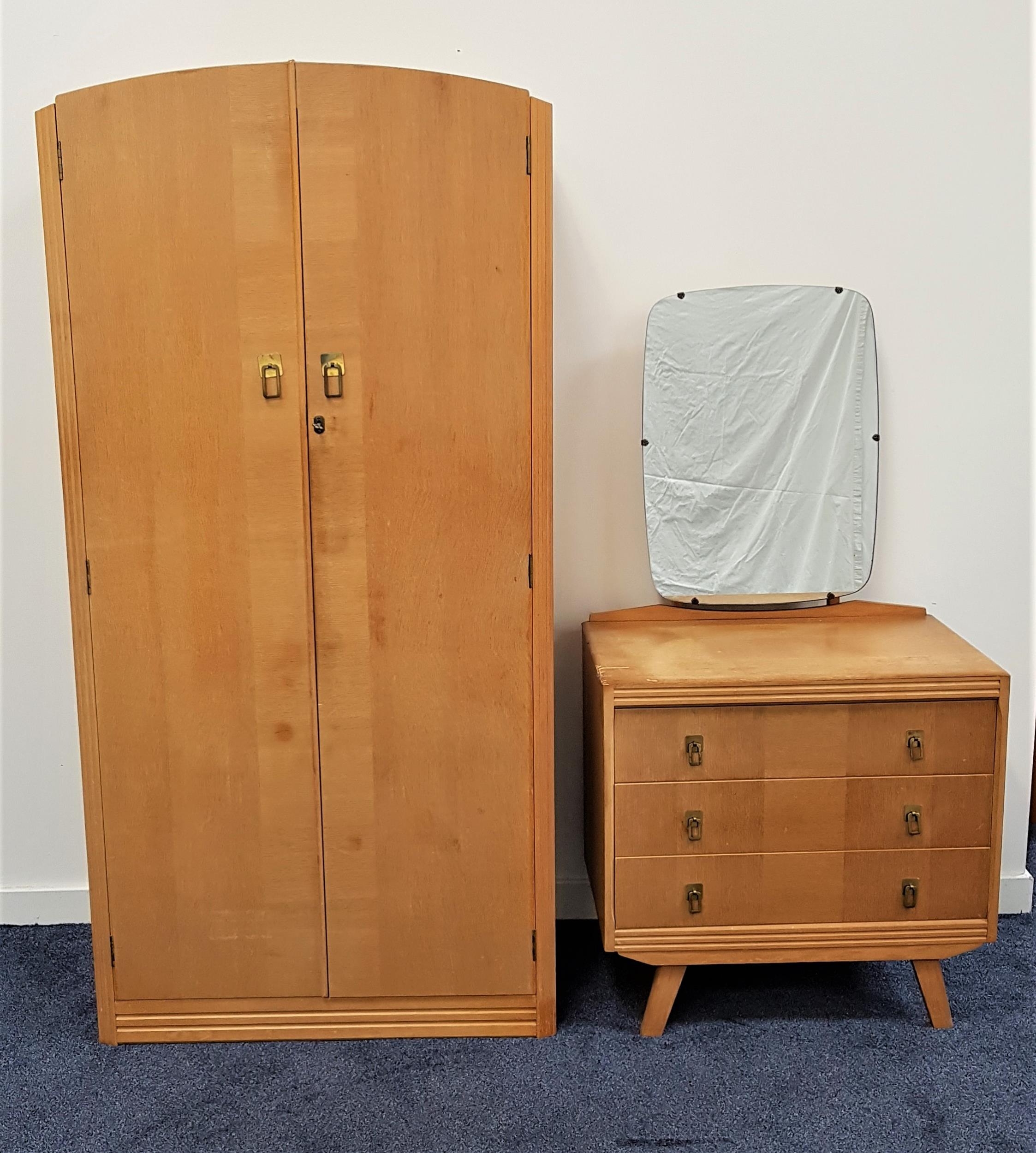 C.W.S. LTD. OAK BEDROOM SUITE comprising a shaped two door wardrobe opening to reveal a mirror,