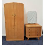 C.W.S. LTD. OAK BEDROOM SUITE comprising a shaped two door wardrobe opening to reveal a mirror,