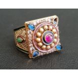 GEM, ENAMEL AND PASTE SET DRESS RING the central cabochon ruby in paste set decorative surround,