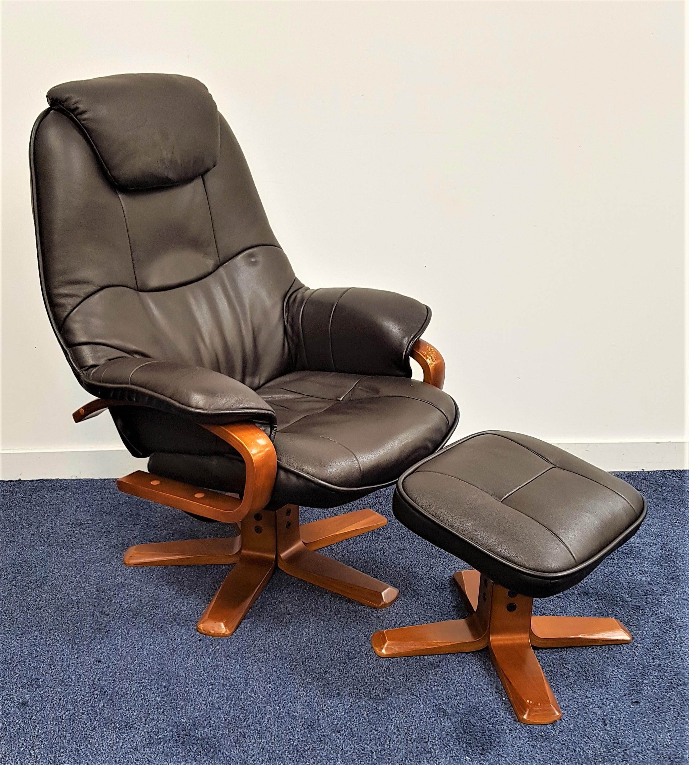 ERKONES STYLE ARMCHAIR with a shaped reclining back on a swivel base, together with a matching