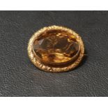 SMOKY TOPAZ SET BROOCH the large oval cut topaz measuring approximately 23mm x 17mm x 11cm, in
