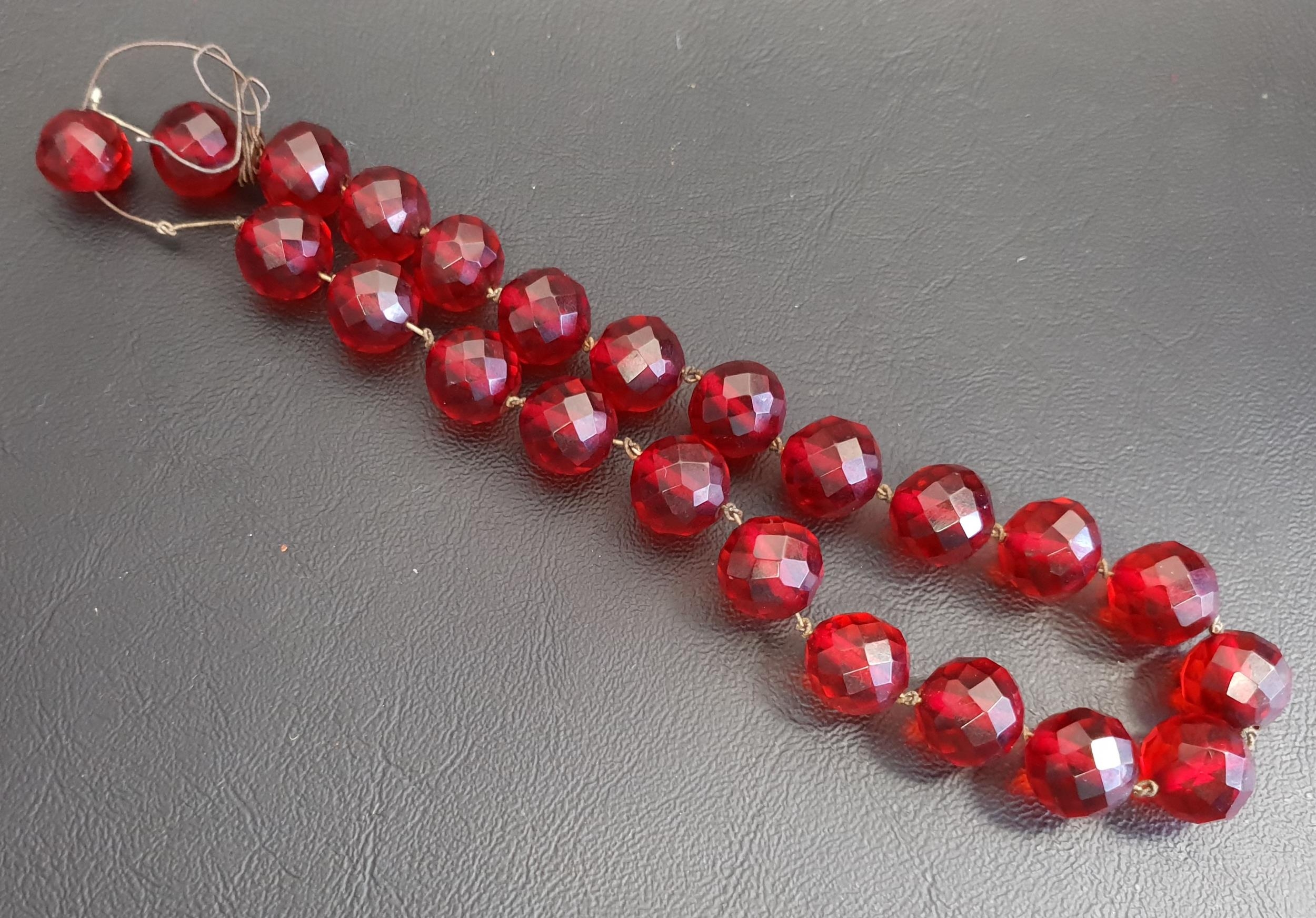 FACETED AMBER BEAD NECKLACE approximately 35.9 grams, with damage to the cord