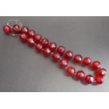 FACETED AMBER BEAD NECKLACE approximately 35.9 grams, with damage to the cord
