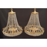 PAIR OF CHANDELIERS with cut glass bead decoration around a brass frame with a lower circular