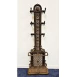 LATE VICTORIAN CAST IRON HALL STAND the shaped pierced top with a lion mask above a pierced back