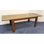 LARGE OAK DINING TABLE with a plank top and extending end sections, standing on plain supports,