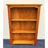 WAXED PINE BOOKCASE with a moulded top above three shelves, 120cm x 89cm