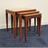 NEST OF TEAK TABLES with inset glass tops, standing on tapering supports, 50.5cm high