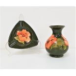 MOORCROFT BALUSTER VASE decorated in the hibiscus pattern with a green ground, 13cm high, together