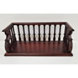 MAHOGANY BOOK RACK the three quarter gallery with turned supports and carved scroll end supports, on