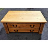 RUSTIC OAK OCCASIONAL TABLE with a plank top above two drawers, standing on plain supports, 50cm x