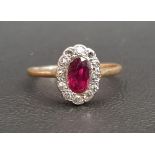 RUBY AND DIAMOND CLUSTER RING the central oval cut ruby in twelve diamond surround, on unmarked gold