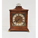 WALNUT BRACKET CLOCK with a brass dial and silvered chapter ring with Roman numerals and a