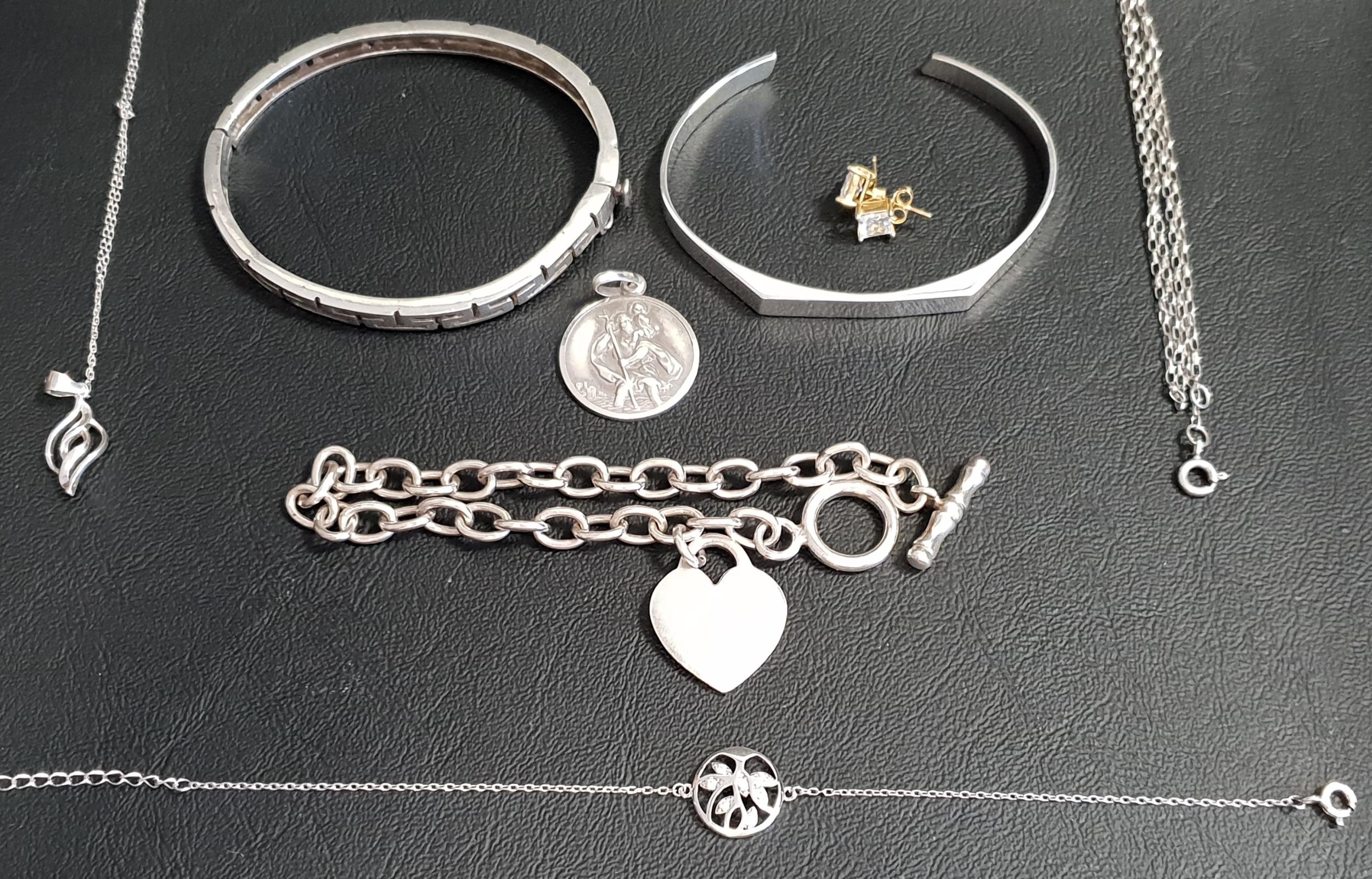 SELECTION OF SILVER JEWELLERY including two bangles, one with Greek key decoration; a Saint