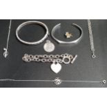 SELECTION OF SILVER JEWELLERY including two bangles, one with Greek key decoration; a Saint