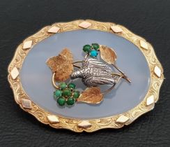 UNUSUAL AGATE SET BROOCH in unmarked gold mount, the centre decorated with silver bird amongst