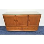 ERCOL LIGHT ELM SIDEBOARD with three cupboard doors above two drawers, on later casters, 129cm wide