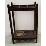 OAK STICK STAND with six apertures above two metal drip pans, on plain supports, 74cm high