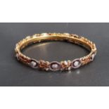 TWENTY-ONE CARAT GOLD BANGLE the relief moulded bangle set with clear paste stones, approximately 13