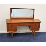 VESPER TEAK BOW FRONT DRESSING TABLE with a rectangular mirror back above an arrangement of five