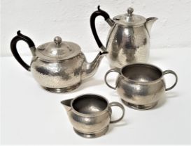 HAMMERED PEWTER TEA SET comprising a tea pot, hot water jug, twin handled sugar bowl and milk jug (