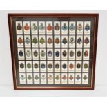 FRAMED SET OF 'SHIP'S BADGES' WILLS'S CIGARETTE CARDS 50 cards in total, frame size 44.5cm x 49cm