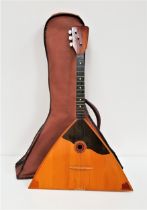 RUSSIAN BALALAIKA with a an arched back and flat triangular front, with three strings, in a soft
