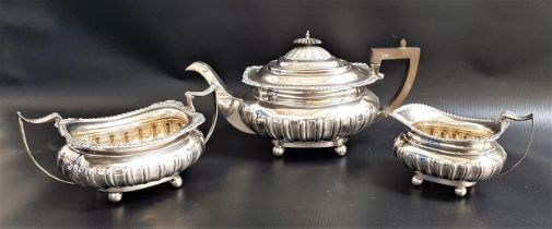 GEORGE V SILVER TEA SET comprising a tea pot, twin handled sugar bowl and milk jug, all on ball