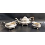 GEORGE V SILVER TEA SET comprising a tea pot, twin handled sugar bowl and milk jug, all on ball