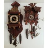 BLACK FOREST CUCKOO CLOCK in a stained pine case with a circular dial with Roman numerals, two