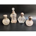 THREE SILVER MOUNTED SCENT BOTTLES London 1891, Sheffield 1896 and Birmingham 1920 and a small glass